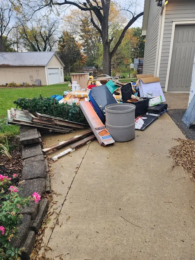 Dumpster being loaded with debris for Roofing Dumpster Rental in Mora